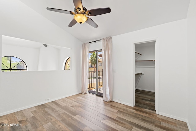 8844 S 51st St Unit 3, Phoenix, AZ 85044 - empty room with a ceiling fan, a healthy amount of sunlight, lofted ceiling, and wood finished floors