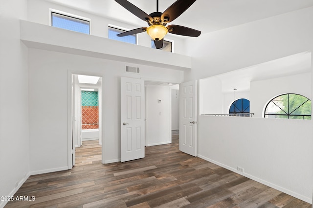 8844 S 51st St Unit 3, Phoenix, AZ 85044 - spare room featuring a ceiling fan, a high ceiling, visible vents, and wood finished floors