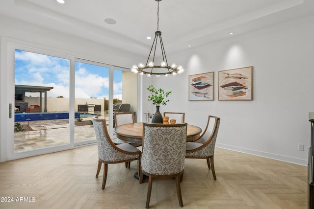 dining room with a chandelier, recessed lighting, a raised ceiling, and baseboards