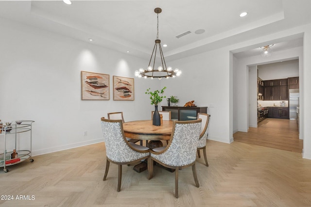 dining area with a chandelier, recessed lighting, visible vents, baseboards, and a tray ceiling