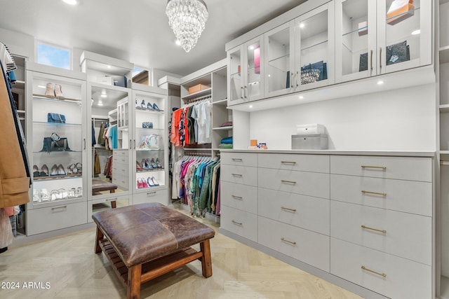 walk in closet featuring a notable chandelier