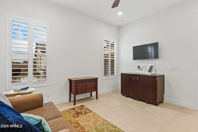 living area featuring recessed lighting, a ceiling fan, and baseboards