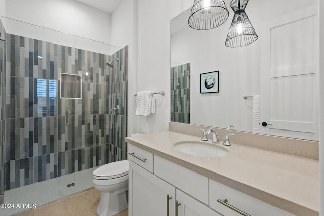 bathroom featuring a stall shower, tile patterned flooring, vanity, and toilet