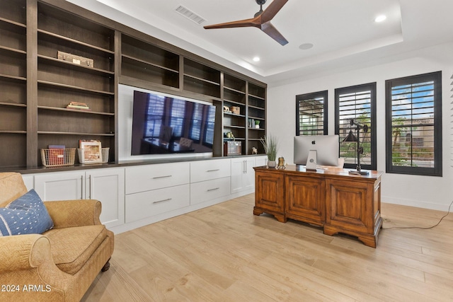 office area featuring light wood finished floors, visible vents, a ceiling fan, a tray ceiling, and recessed lighting