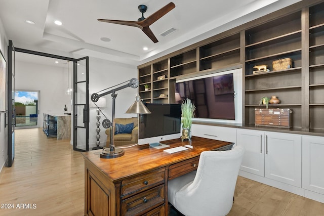 office space featuring light wood finished floors, visible vents, a ceiling fan, built in study area, and recessed lighting