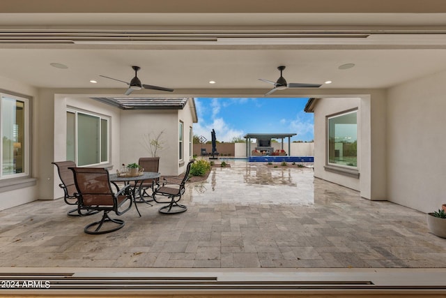 view of patio featuring outdoor dining space and a ceiling fan