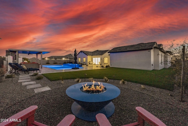 view of patio / terrace with a fire pit and a fenced in pool