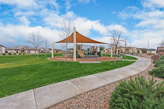 view of community with a residential view, playground community, and a yard