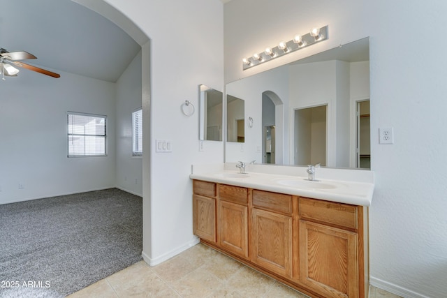 full bath featuring a sink, a ceiling fan, tile patterned floors, and vaulted ceiling