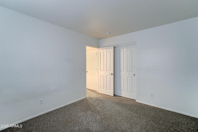 carpeted spare room with baseboards