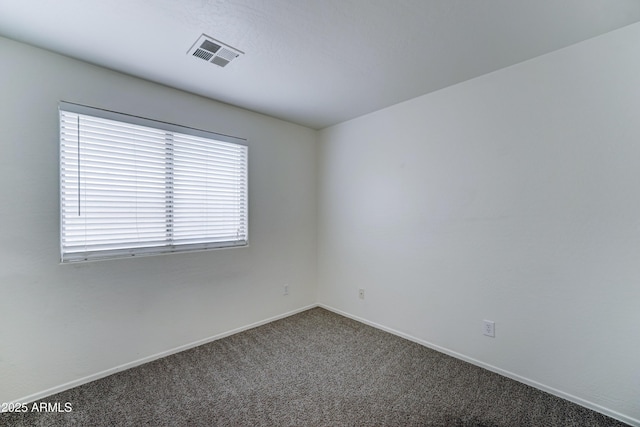 unfurnished room featuring visible vents, carpet flooring, and baseboards