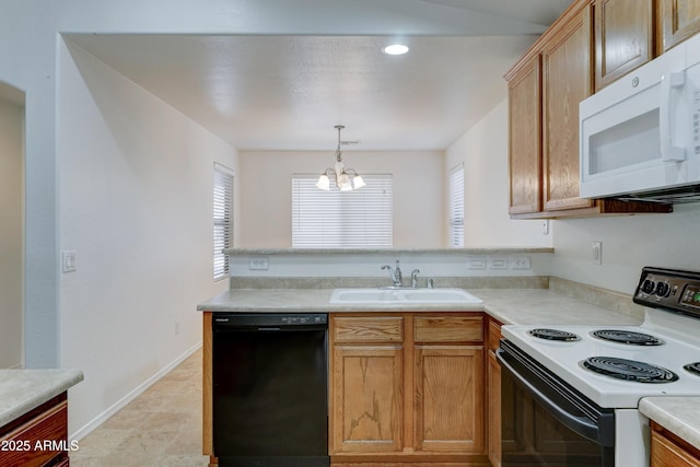 kitchen with electric stove, a sink, a peninsula, white microwave, and dishwasher