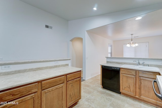 kitchen featuring visible vents, a sink, decorative light fixtures, black dishwasher, and light countertops