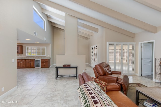 living area featuring beverage cooler, high vaulted ceiling, beamed ceiling, and baseboards