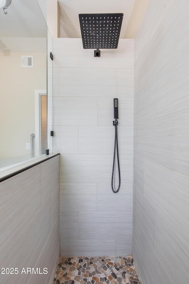 full bathroom with tiled shower