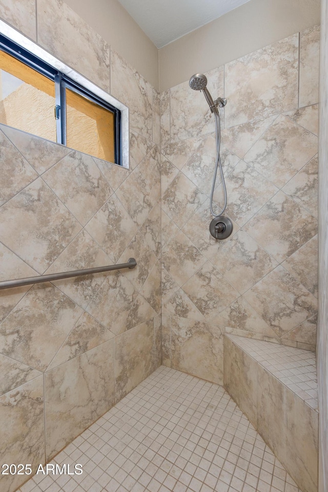bathroom with tiled shower