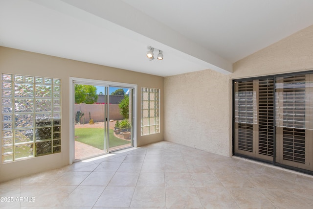unfurnished sunroom featuring lofted ceiling