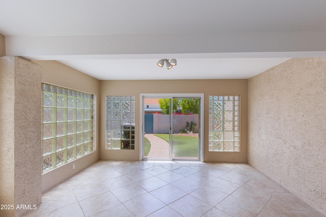 tiled empty room with plenty of natural light