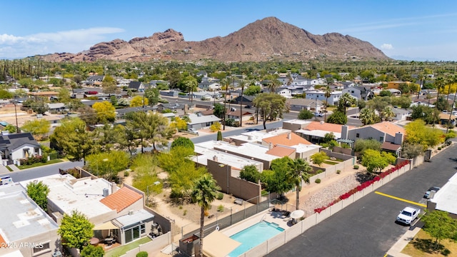 aerial perspective of suburban area with a mountainous background and a pool