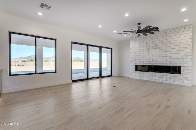 unfurnished living room featuring baseboards, recessed lighting, visible vents, and light wood-style floors