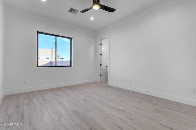 unfurnished room featuring baseboards, a ceiling fan, visible vents, and light wood-style floors