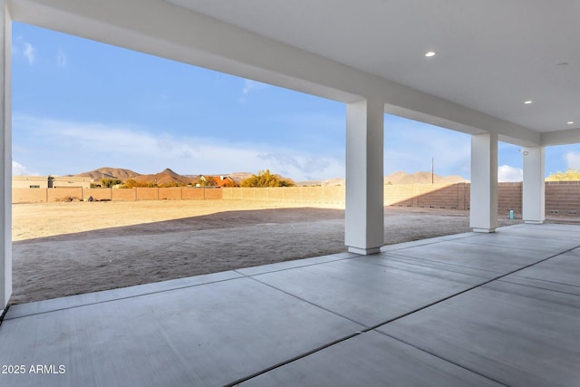 view of patio with a fenced backyard and a mountain view