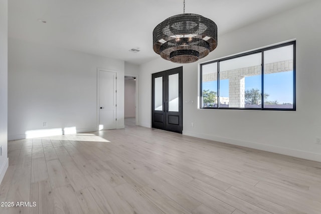 foyer entrance featuring light wood finished floors and baseboards