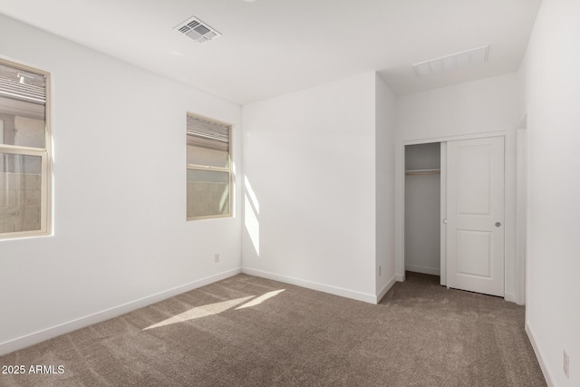 unfurnished bedroom with carpet floors and a closet