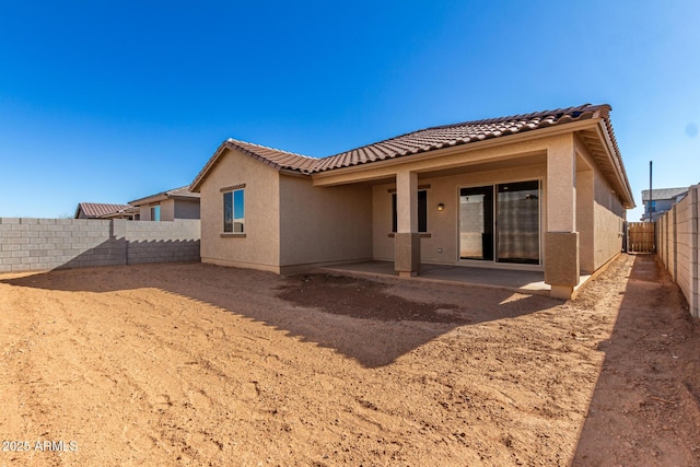 back of house with a patio