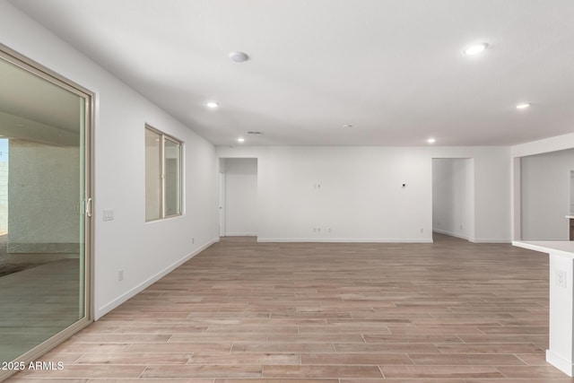 spare room featuring light hardwood / wood-style floors