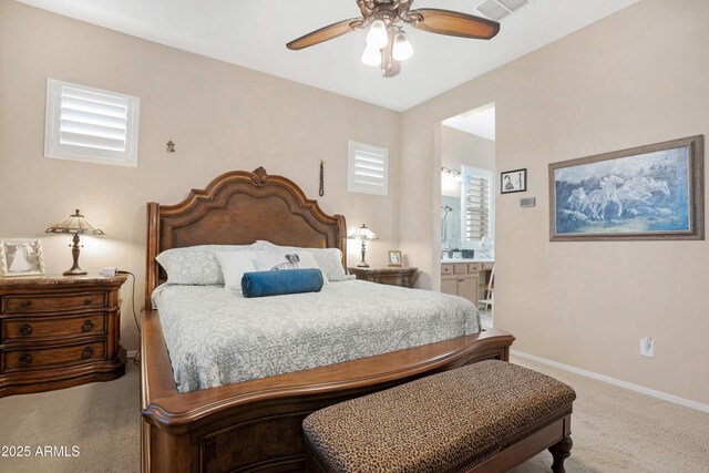 carpeted bedroom featuring visible vents, baseboards, a ceiling fan, and ensuite bathroom