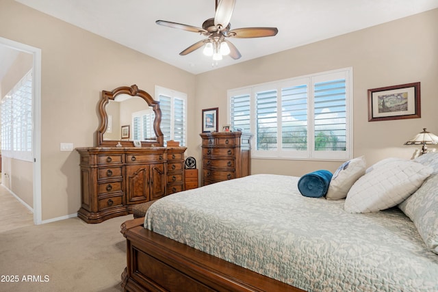 bedroom with baseboards, ceiling fan, and light colored carpet