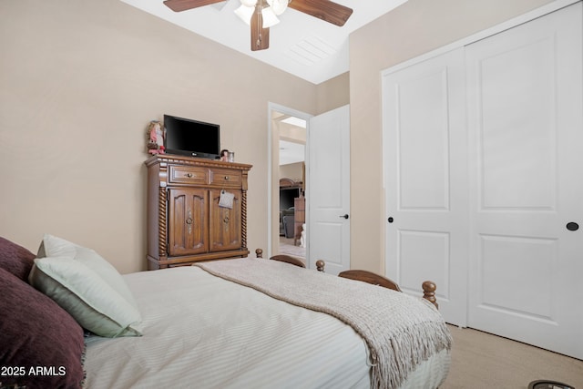 bedroom with a closet, a ceiling fan, and light colored carpet