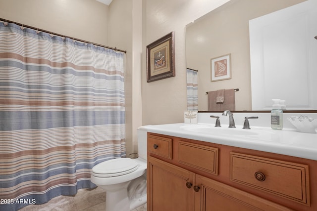 bathroom featuring curtained shower, vanity, and toilet