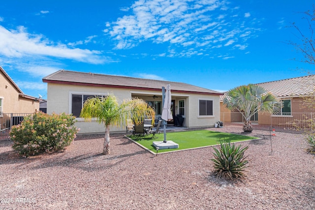 back of house featuring ceiling fan, a patio, fence, and stucco siding