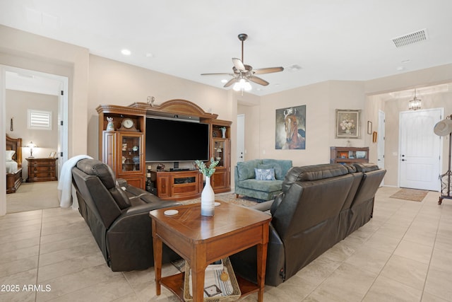 living area featuring ceiling fan, light tile patterned flooring, and visible vents