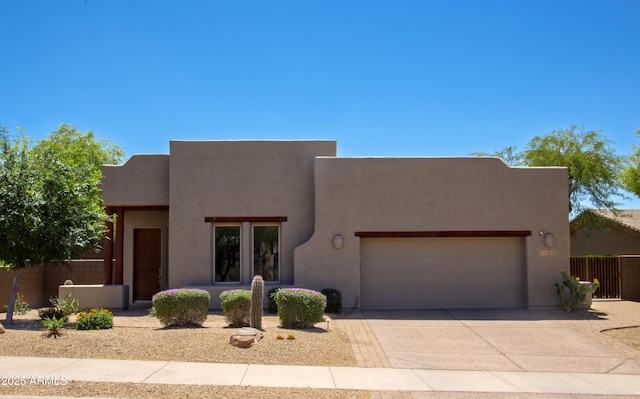 14045 E Geronimo Rd, Scottsdale, AZ 85259 - adobe home with fence, an attached garage, concrete driveway, and stucco siding