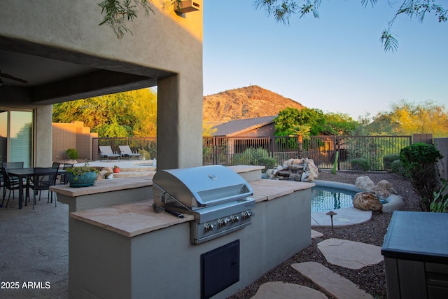14045 E Geronimo Rd, Scottsdale, AZ 85259 - view of patio / terrace with area for grilling, outdoor dining area, a mountain view, a fenced backyard, and a grill