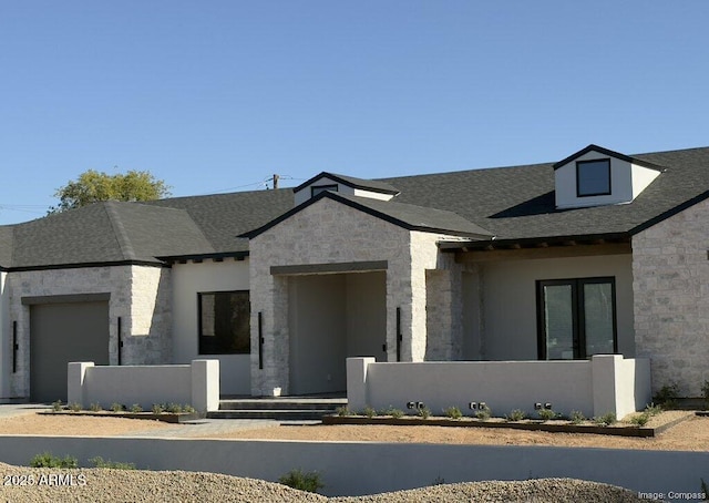 8521 E Desert Cove Ave, Scottsdale, AZ 85260 - view of front of property featuring stone siding, a garage, and a fenced front yard