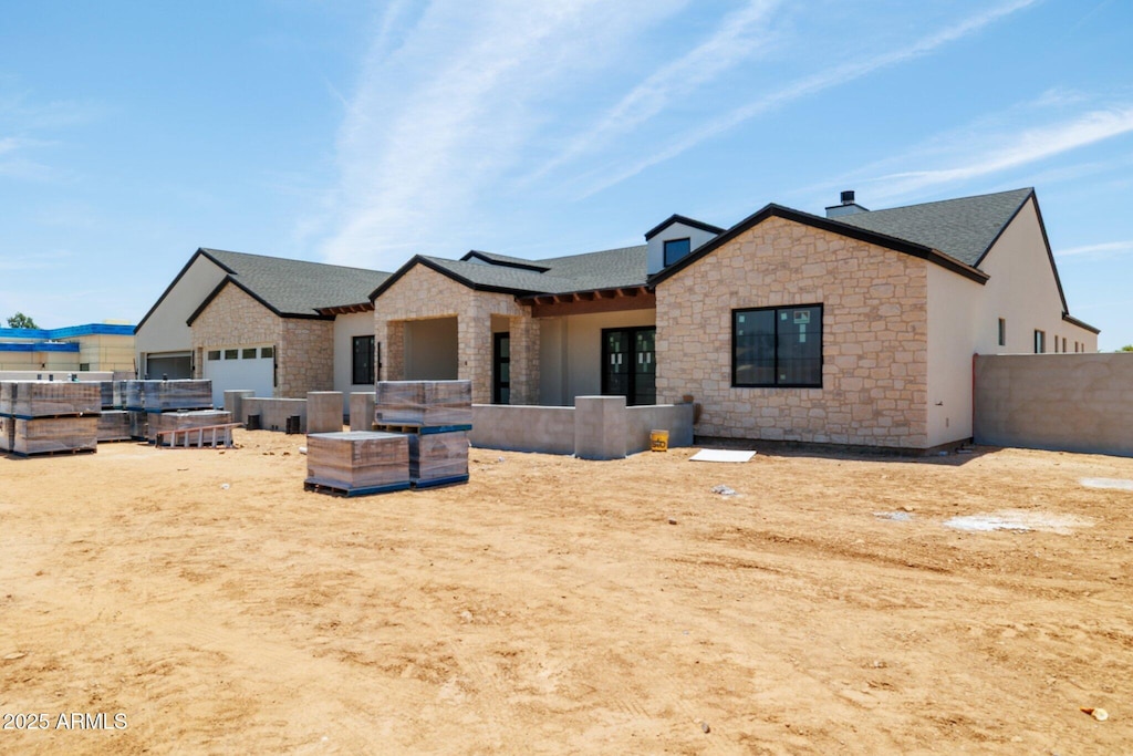 8521 E Desert Cove Ave, Scottsdale, AZ 85260 - back of house with stone siding and roof with shingles