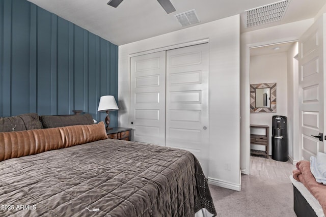 carpeted bedroom featuring a closet, baseboards, and a ceiling fan