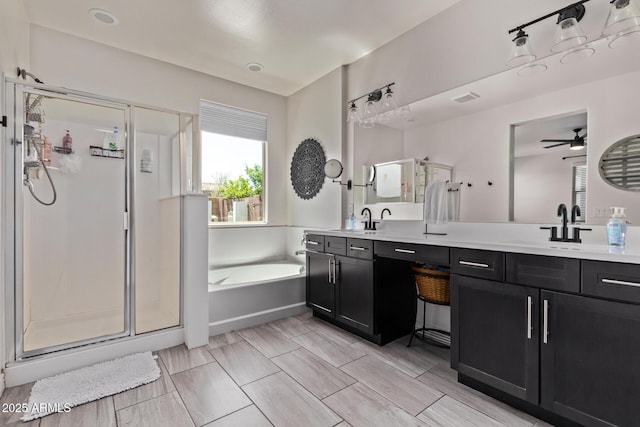 bathroom with a shower stall, a bath, double vanity, and ceiling fan