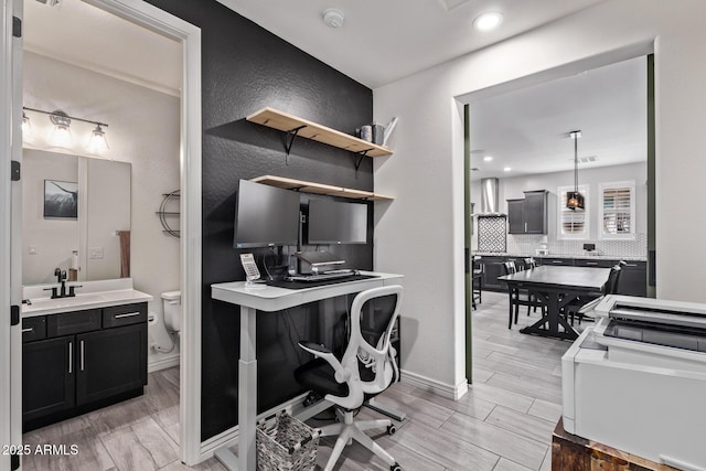 office with a sink, wood tiled floors, recessed lighting, and baseboards