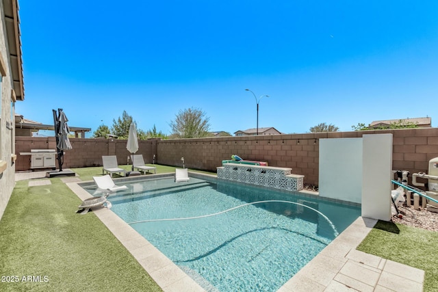 view of swimming pool with a fenced backyard
