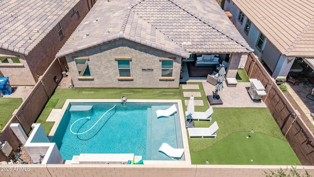 view of swimming pool with a putting area, a fenced backyard, a patio, and an outdoor hangout area