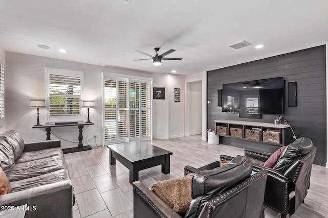 living room with a ceiling fan, recessed lighting, and baseboards