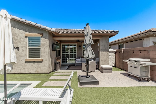 back of house with a patio area, an outdoor living space, fence, and stucco siding
