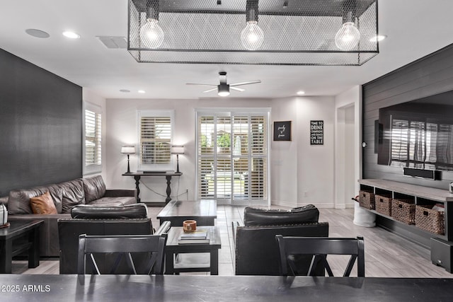 living room with ceiling fan, recessed lighting, baseboards, and wood finished floors