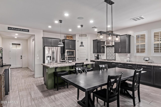 dining room with recessed lighting and baseboards