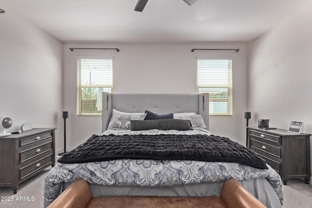 bedroom featuring light colored carpet, multiple windows, and ceiling fan